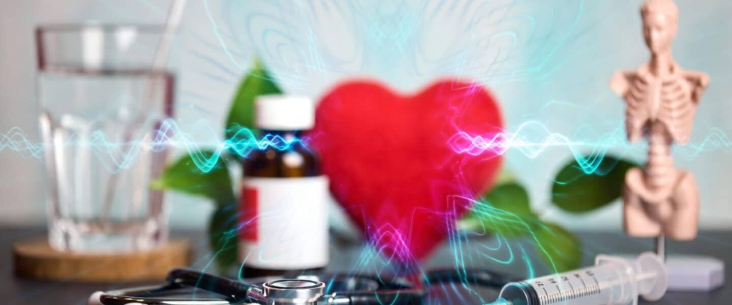 Abstracte weergave van hartgezondheid met medicatie, stethoscoop en anatomisch model op de achtergrond